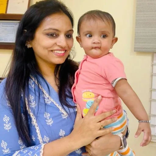 A patient at Neo Fertility Clinic holding her baby